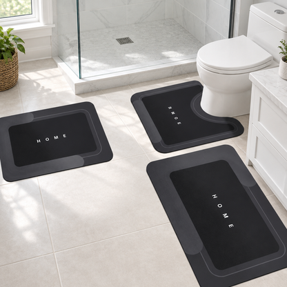Black 3-piece bath mat set laid out in a bathroom